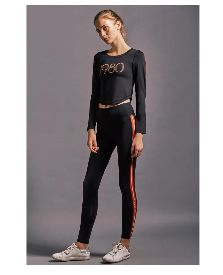 GYMNA RED SIDE STRIPE LEGGINGS IN BLACK