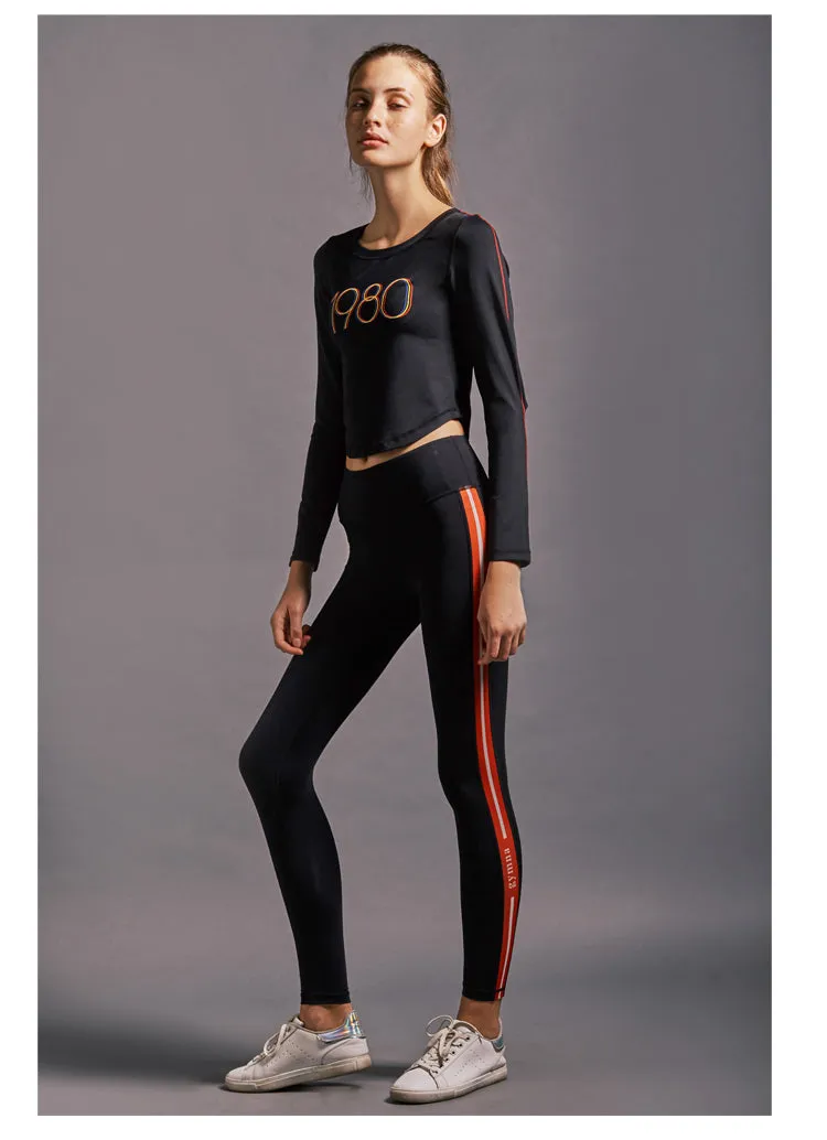 GYMNA RED SIDE STRIPE LEGGINGS IN BLACK